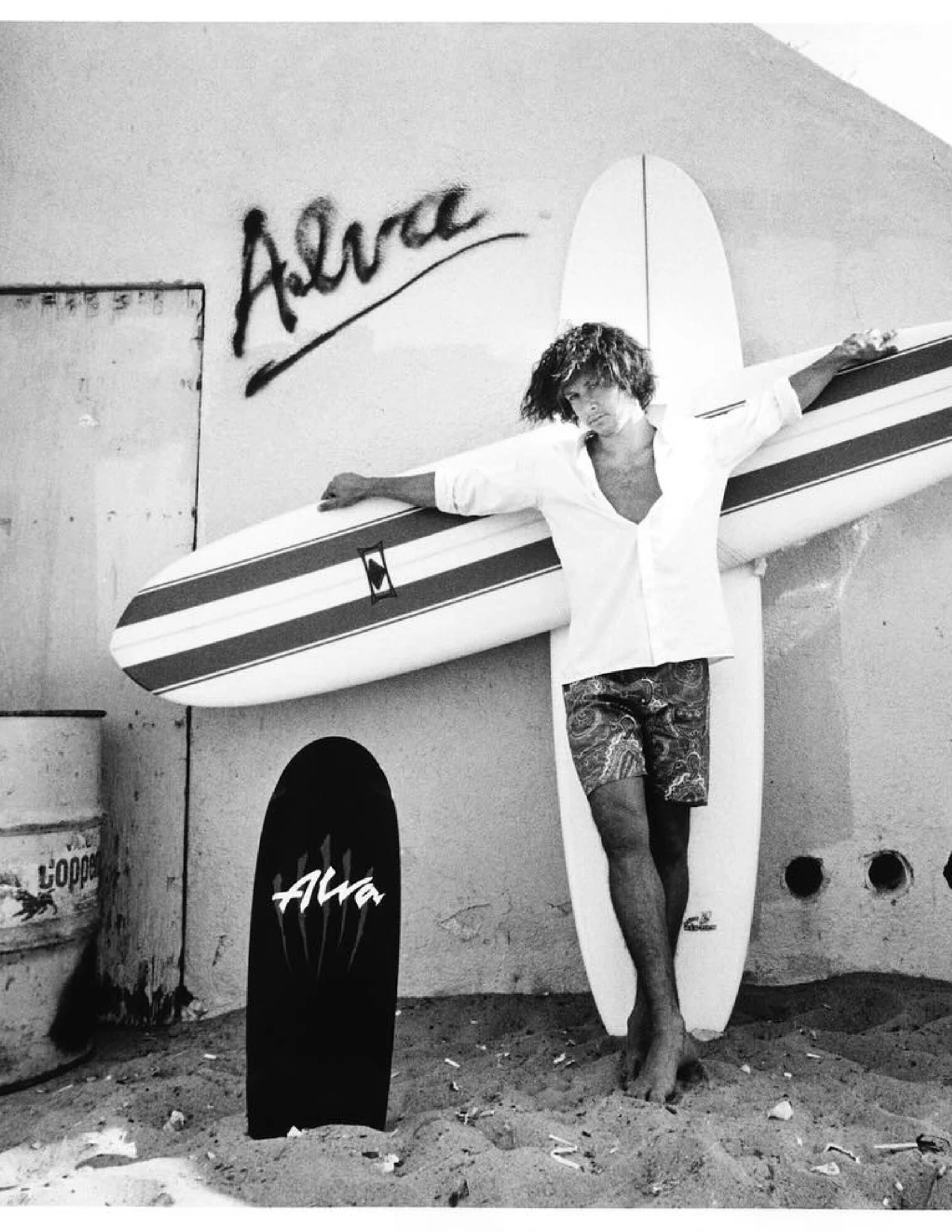 Tony Alva with surfboards and an Alva skateboard